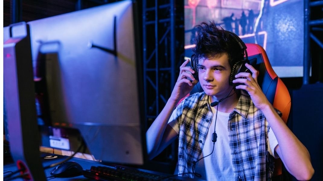 Cover image of the blog called Buying Kick followers featuring a man wearing headphones and looking at a computer